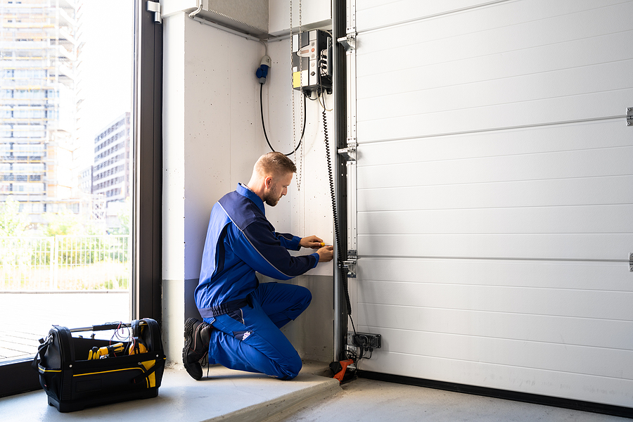 Garage Door Installation And Repair At Home. Contractor Man In H